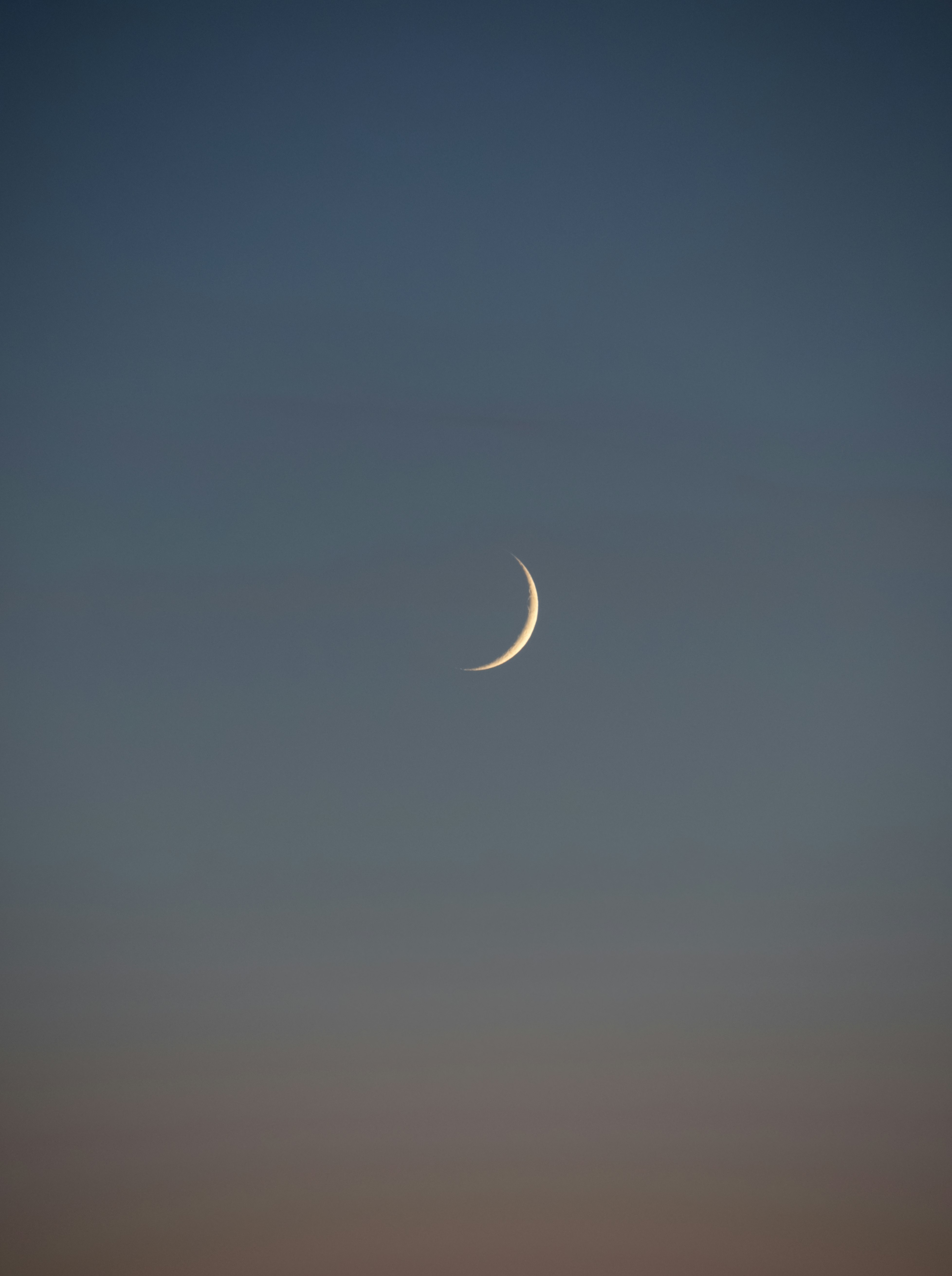 white crescent moon in the sky